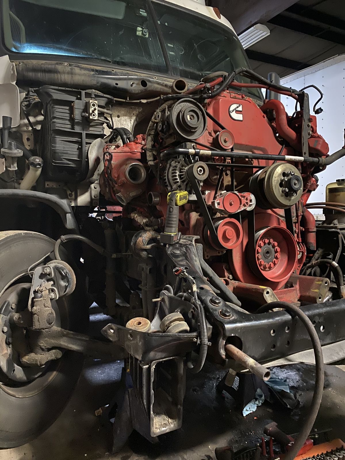 Close view of a red diesel engine and truck chassis