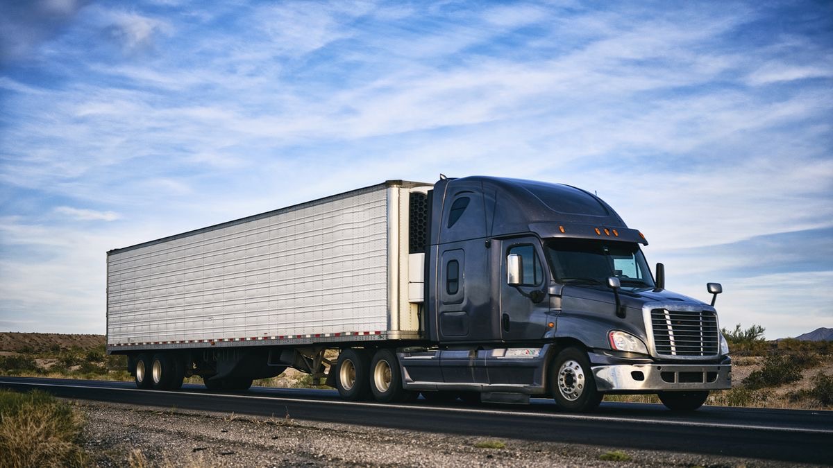 Semi-truck with a refrigerated trailer on the highway